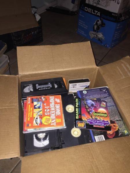 A box of vhs videos and computer games and other games