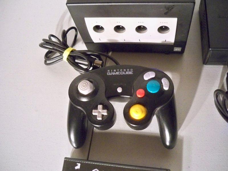 Black Nintendo Gamecube with one controller, Cars game, etc