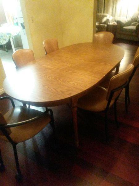 extendable wooden table with 6 padded chairs