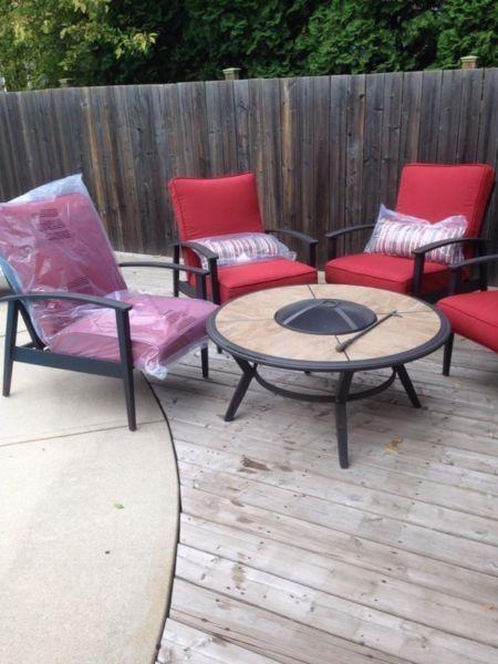 Patio set. 4 chairs with cushions and fire bowl rable