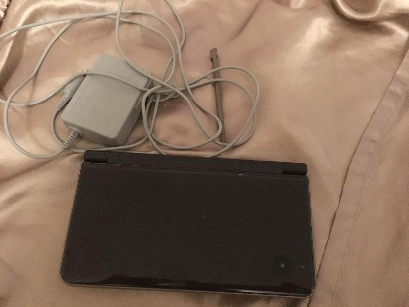 Nintendo DSi XL, charger, and stylus