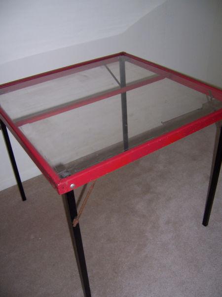 red card table with clear top and black legs