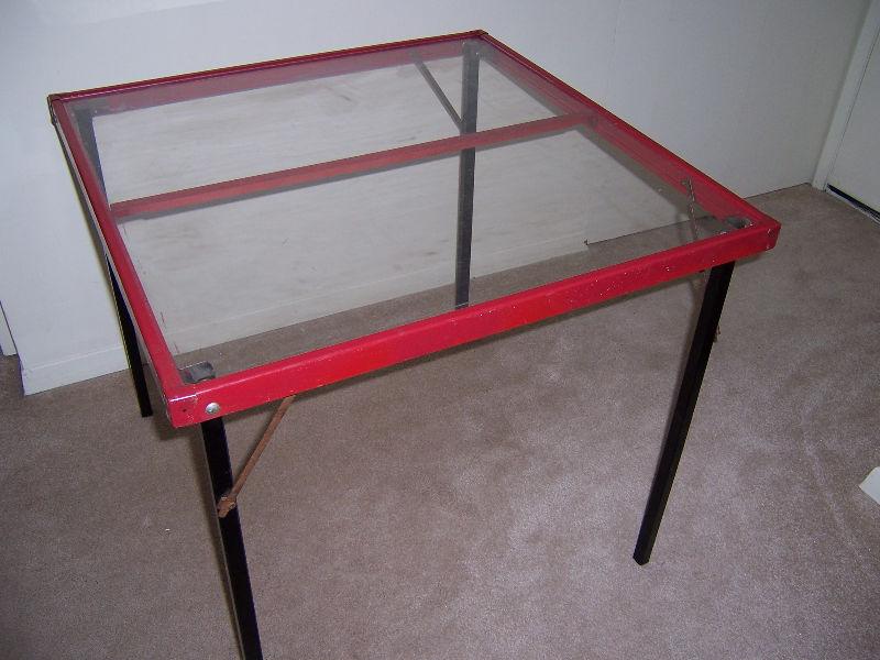 red card table with clear top and black legs