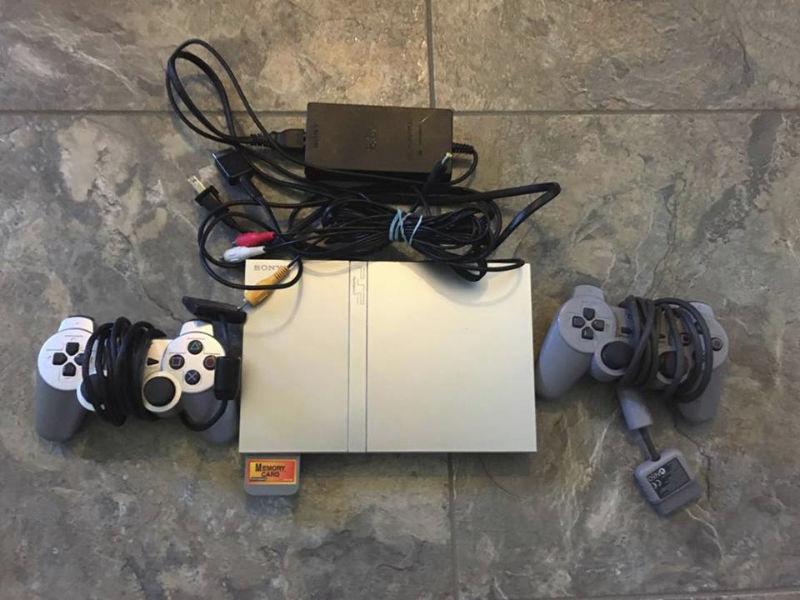 Silver PS2 Slim with two controllers and memory card