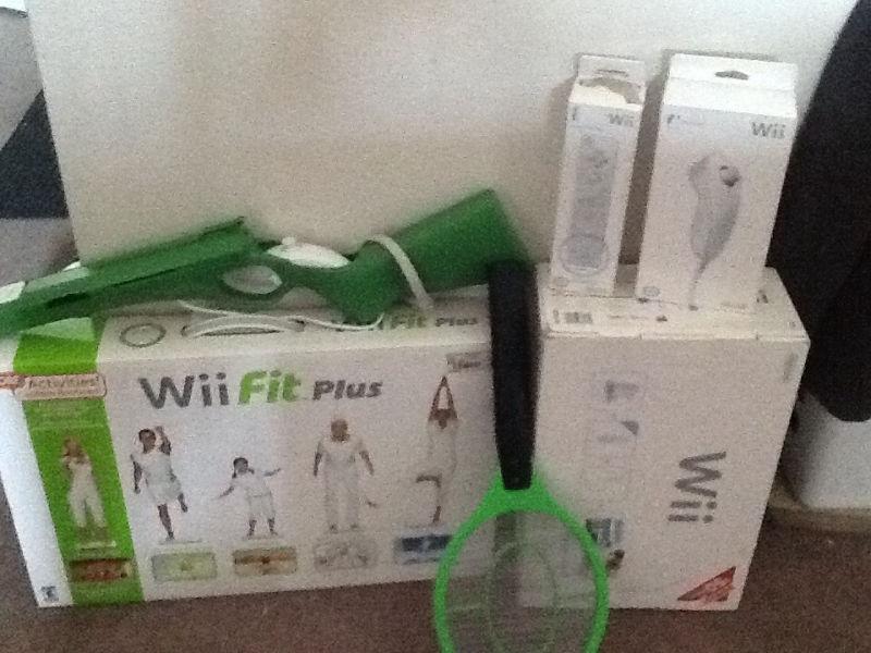 Wii Game Console, extra remote and nunchuck , Wii Fit Board, etc