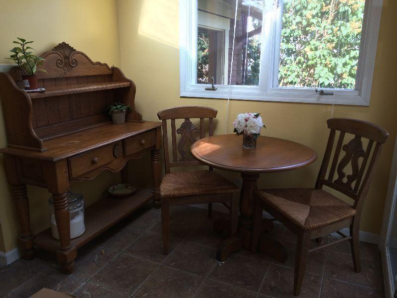 Solid wood. Kitchen hutch, table and 2 chairs with wicker seats