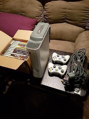 New condition Xbox 360/wi-fi with 14 games 2 pads