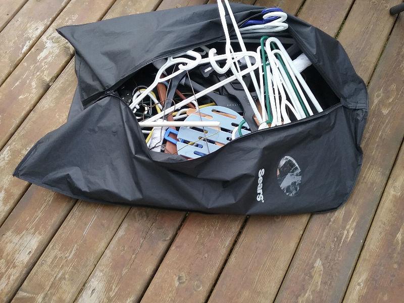 Suit bag full of various clothes hangers (pants and shirts)