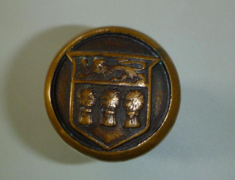 antique brass door knob with crest