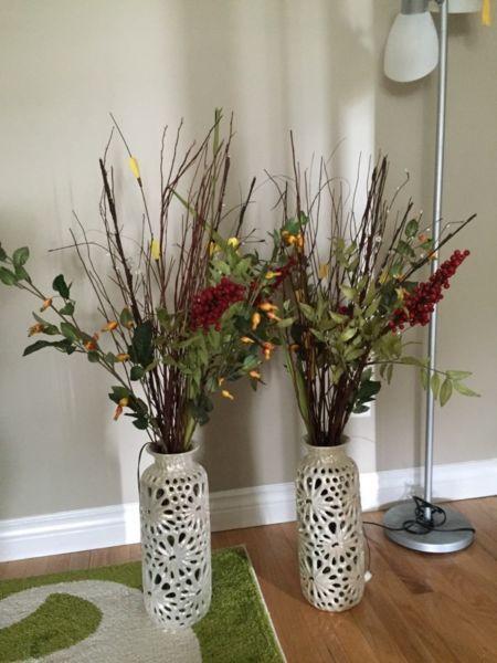A pair of vases with flowers