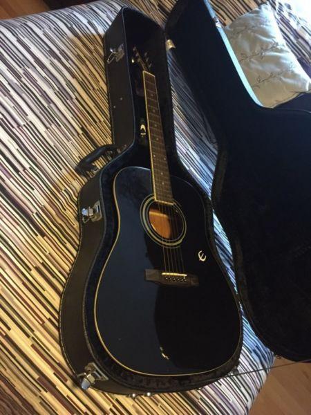 Black Epiphone acoustic guitar with Ritter hard case