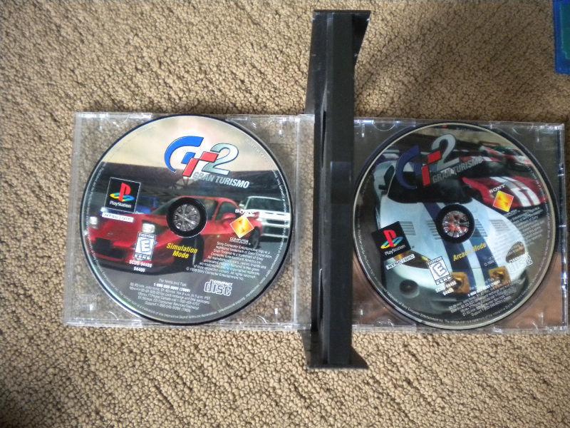 PS2 System/ Racing Wheel and 2 games