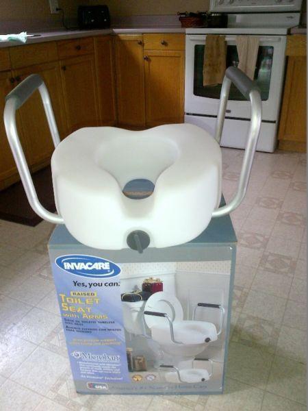 Raised toilet seat with arms- Invacare