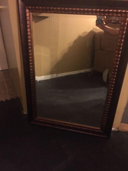 Brown and bronze framed mirror