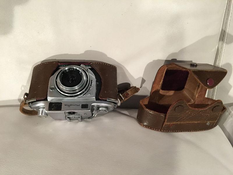 Antique Minolta Camera with case, manuals and flash attachment