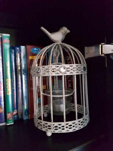 Bird cage tea light holder has jewels on outside