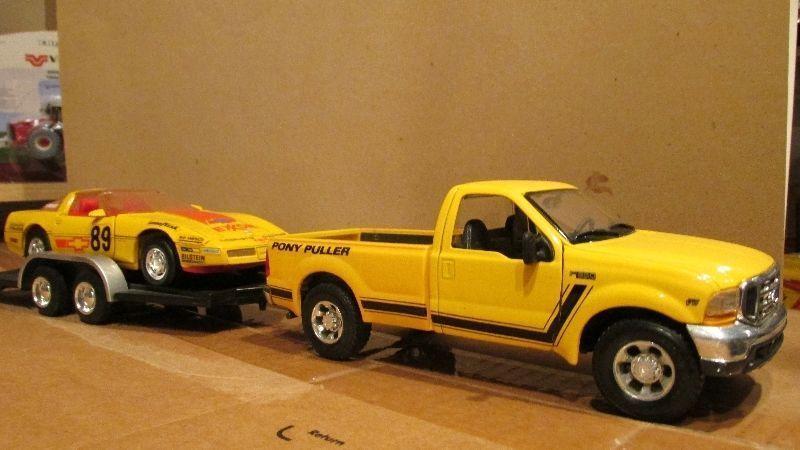 Diecast cars and a truck with trailer