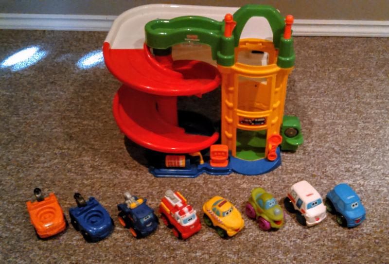 Little people garage with 7 trucks