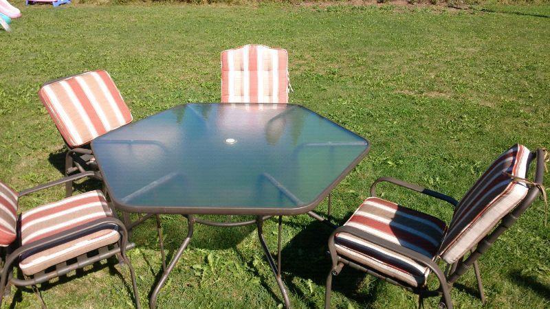 Glass patio table with four chairs