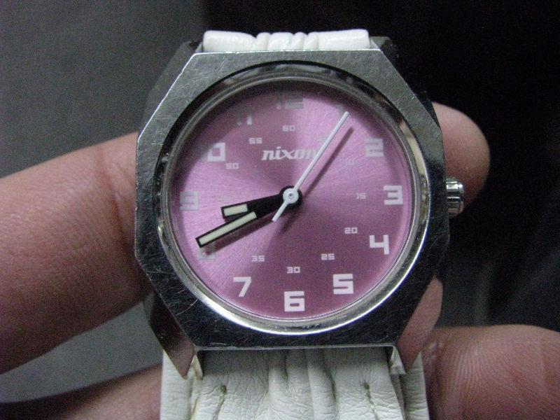 WOMAN NIXON WATCH..CHROME CASE AND PINK DIAL